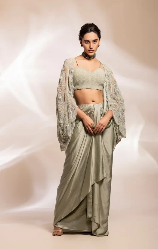 Cape worn over bustier and wrap lungi skirt